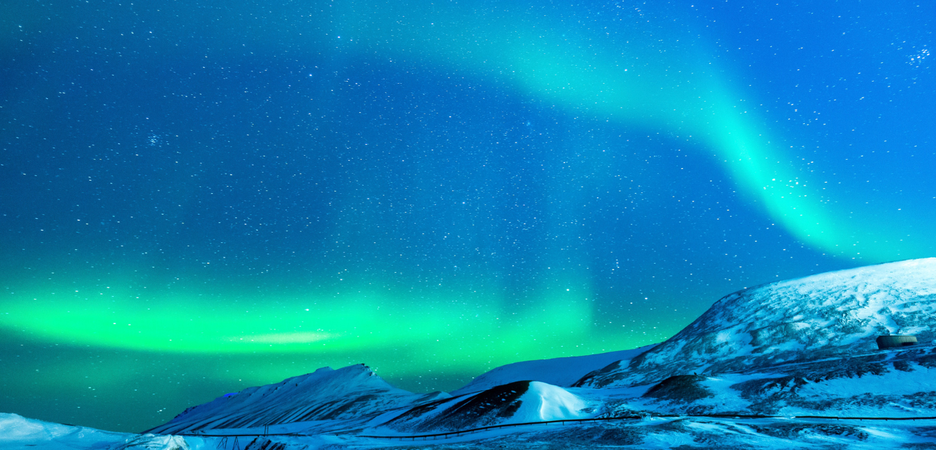 a picture of mountains with an aurora belt
